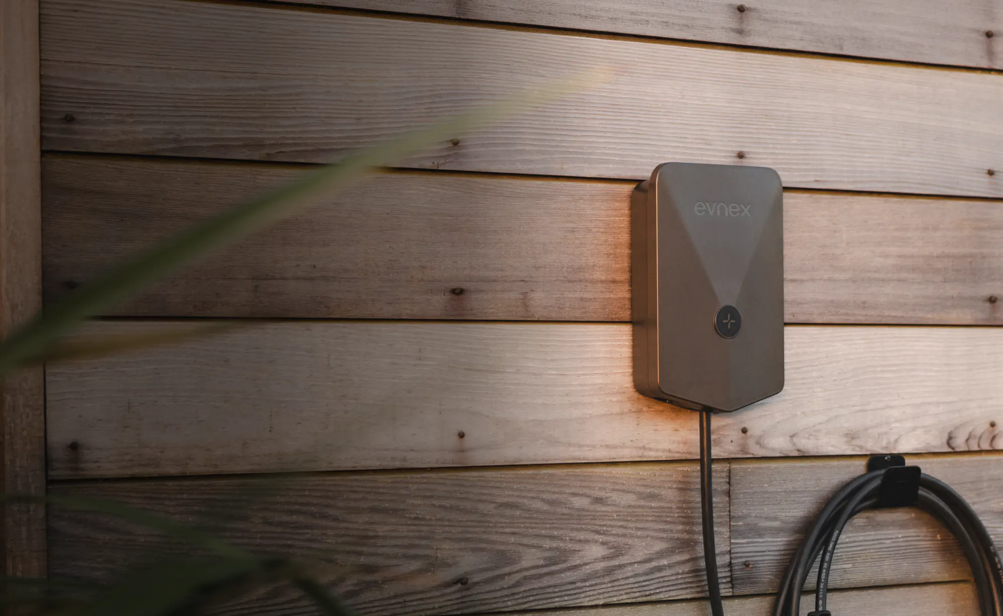 Evnex charger mounted on a timber wall